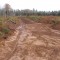 The road bed prepared for placement of borrow material, with a culvert ready to be installed.